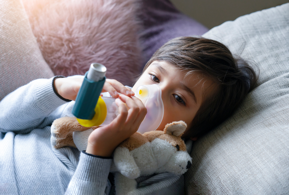 child using inhaler at night