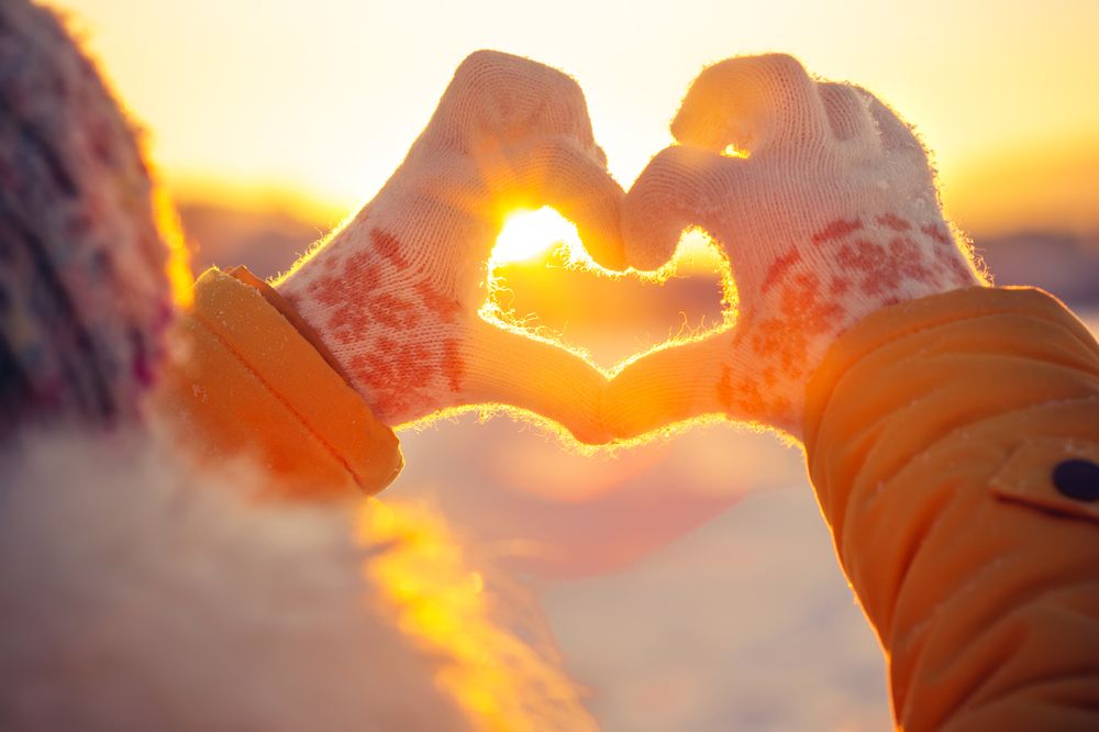 woman holding up a heart