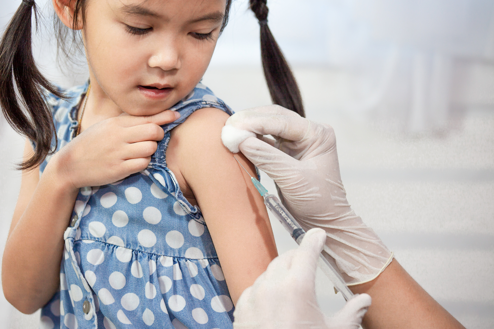 child receiving vaccination.